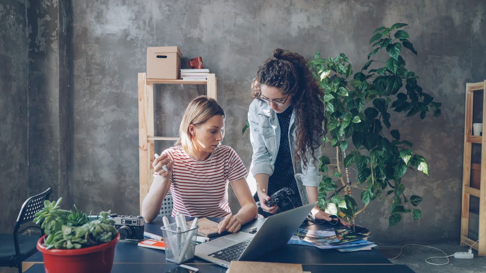 A team working together around a laptop
